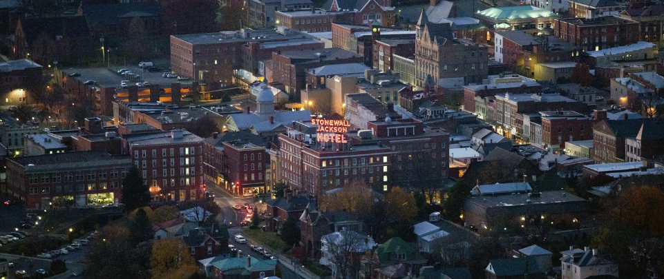 An aerial view of downtown Staunton's buildings at dusk. 