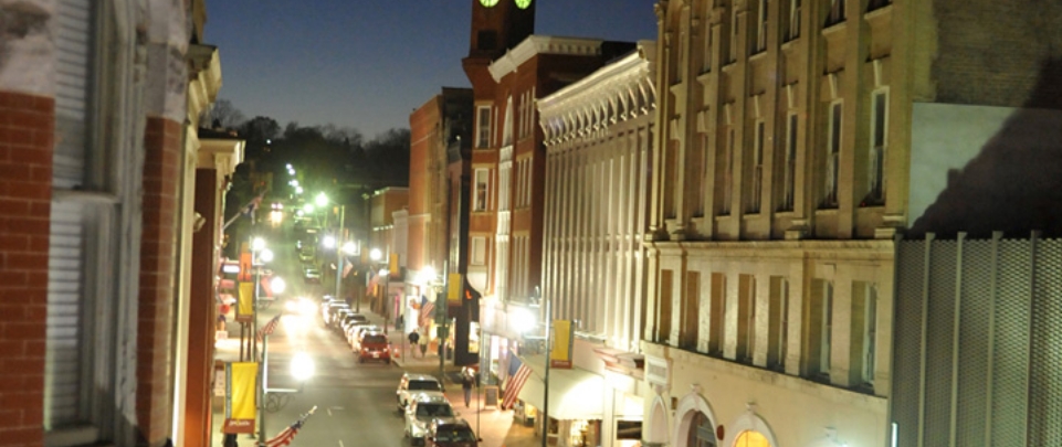 The illuminated buildings, shops and streets of downtown Staunton Virginia at dusk. 