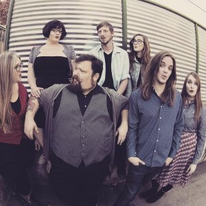 The Judy Chops band standing in front of a metal door in Staunton, VA