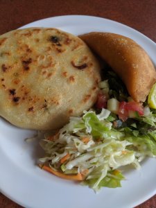 A vibrant plate featuring a tortilla, fresh salad, and creamy coleslaw, celebrating Hispanic Heritage Month with delicious flavors