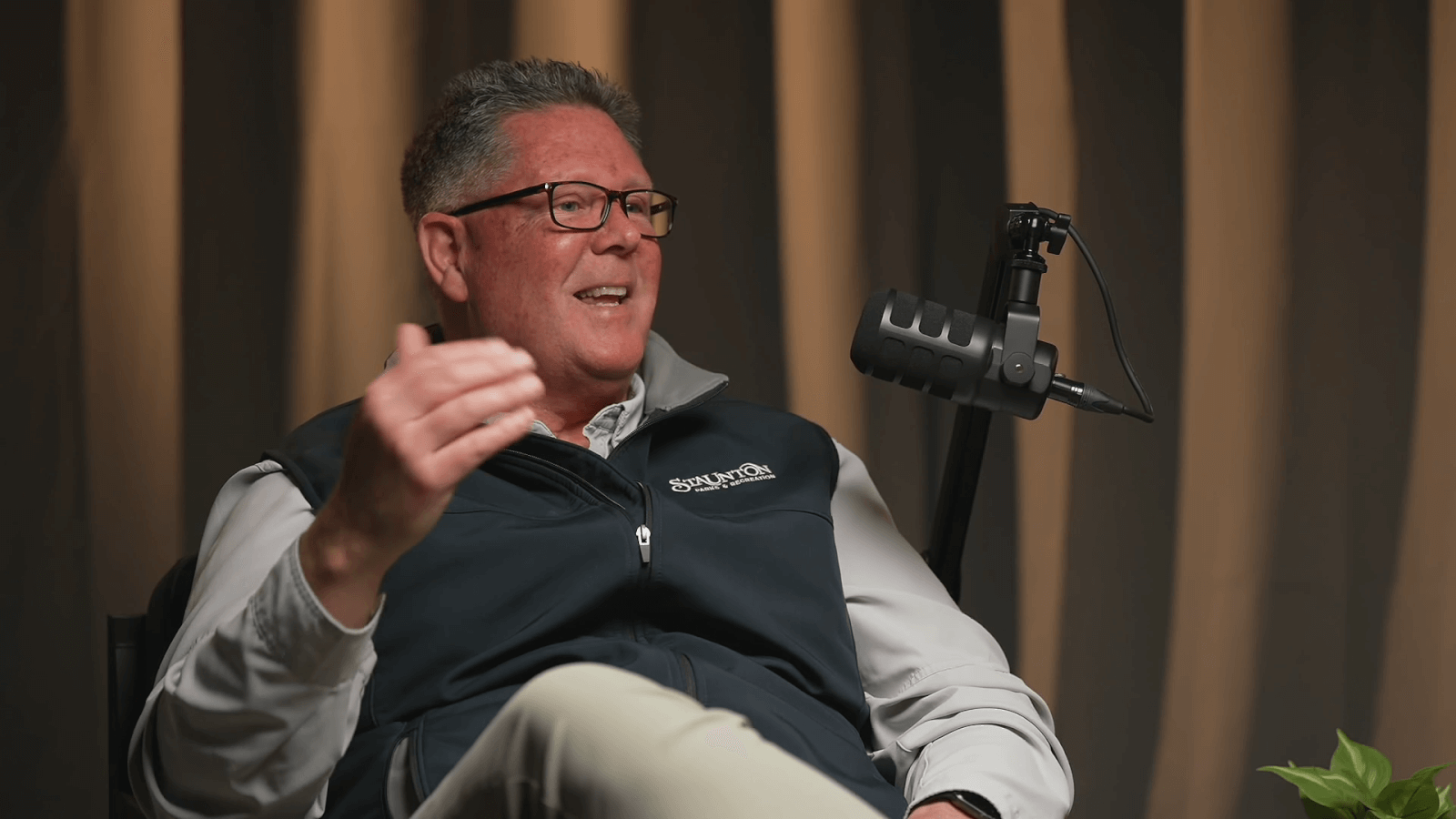 Parks director, Chris Tuttle, sits at a podcast mic talking