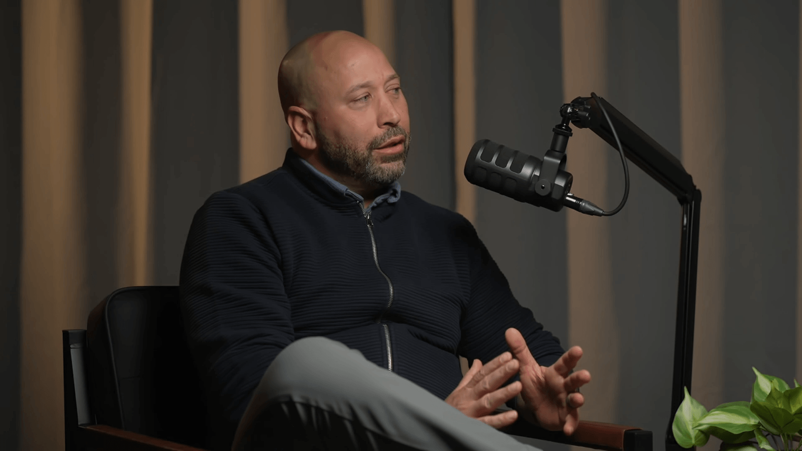 Tony speaks into a podcast microphone